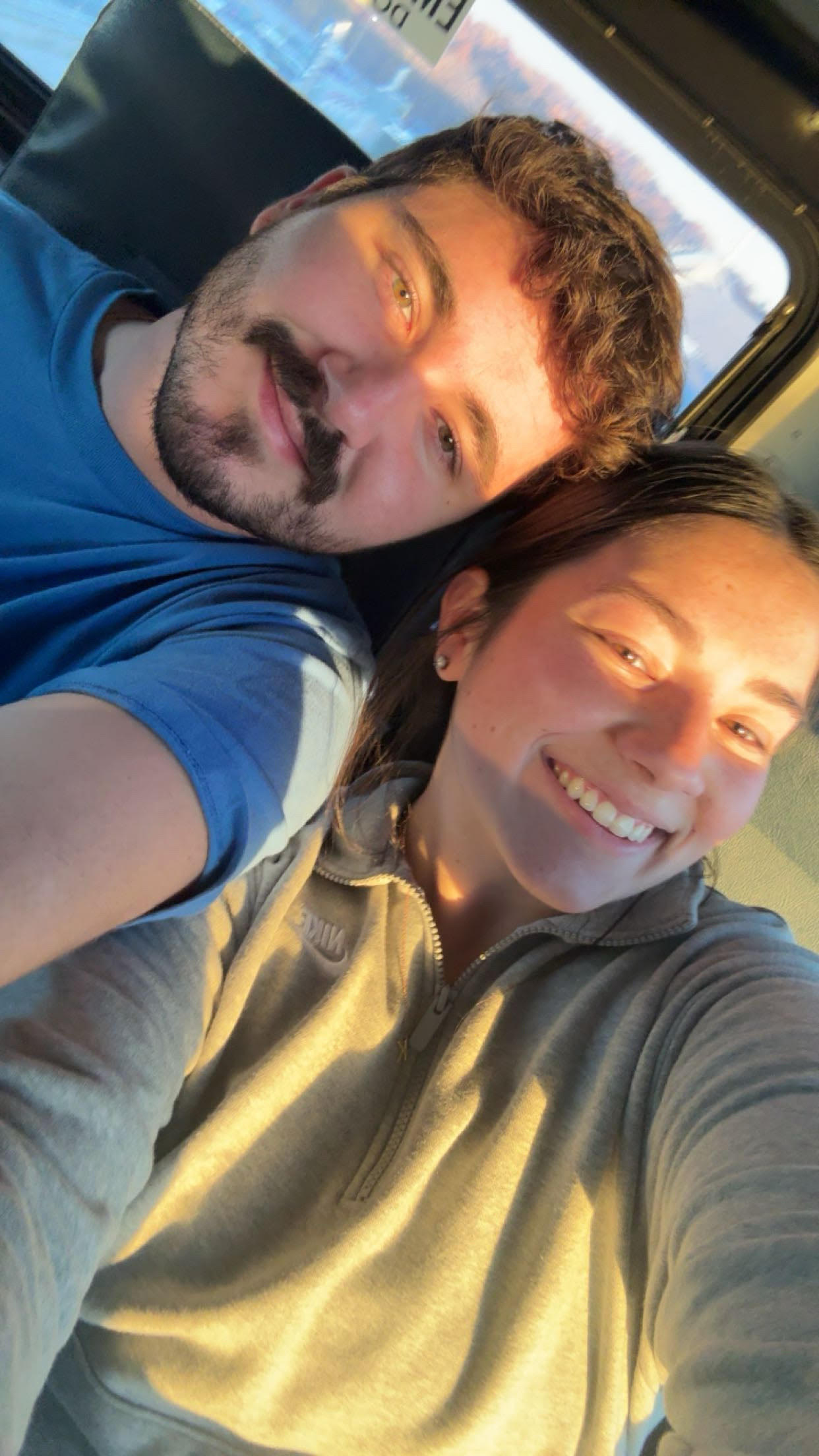 Jayden and Kyle smiling in warm golden-hour light